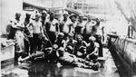 Crew of USS Denver (C-14) cleaning after coaling 